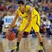 Michigan sophomore Trey Burke dribbles the ball as he runs time off the clock during the last minute of play in overtime at Cowboys Stadium in Arlington, Texas on March 29, 2013. Melanie Maxwell I AnnArbor.com